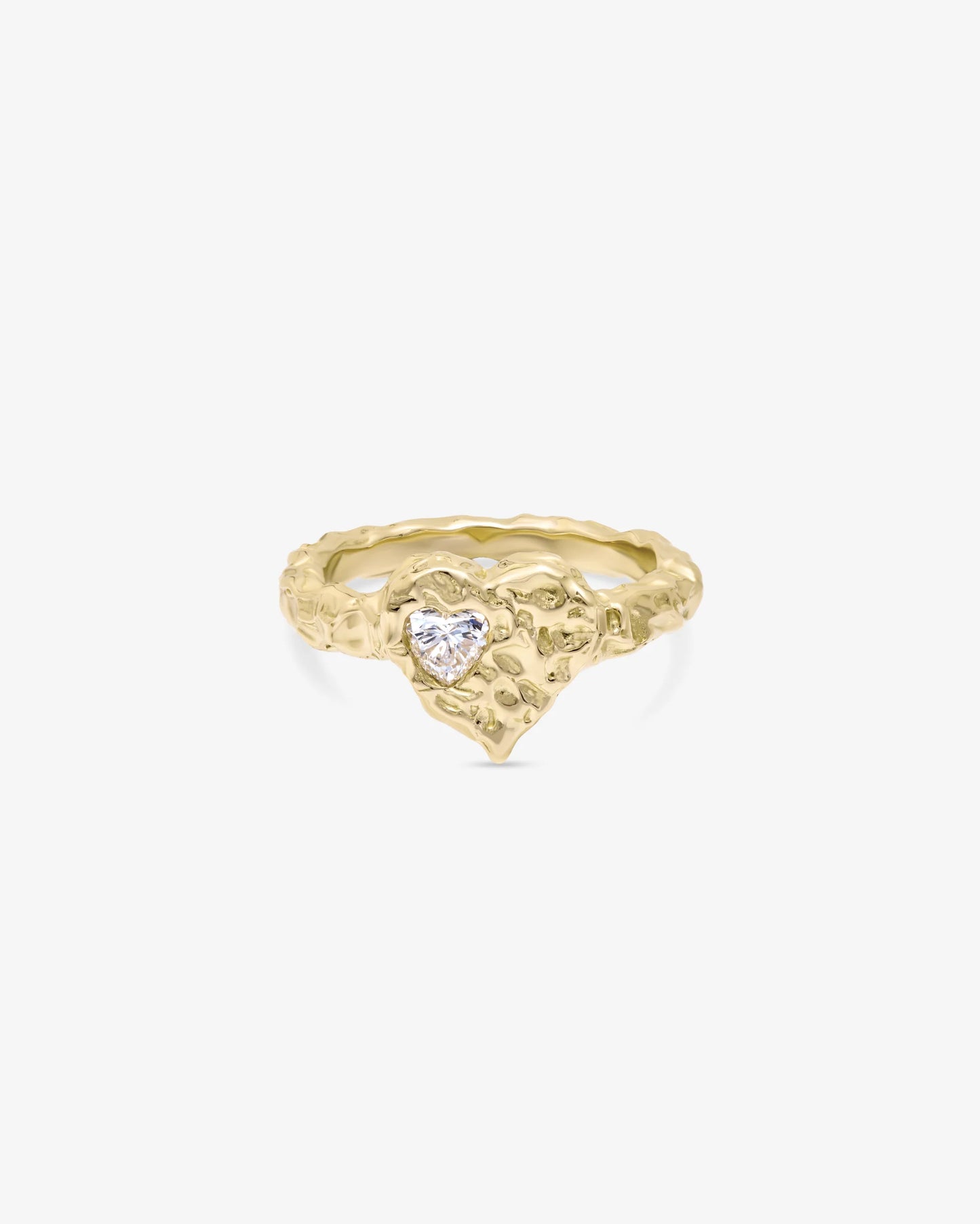 Gold ring with a heart-shaped gemstone on a white background