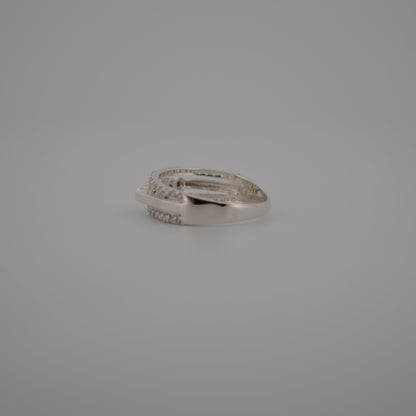Silver ring with small diamonds on a gray background