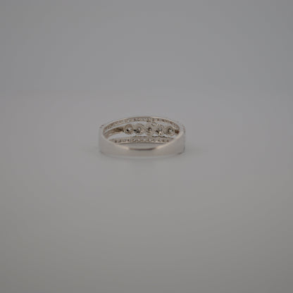 Silver ring with small diamonds on a gray background