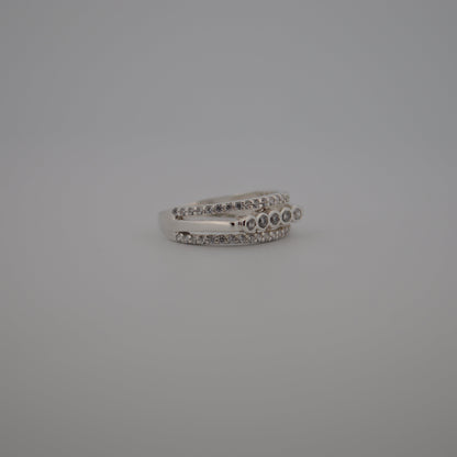 Silver ring with small stones on a gray background