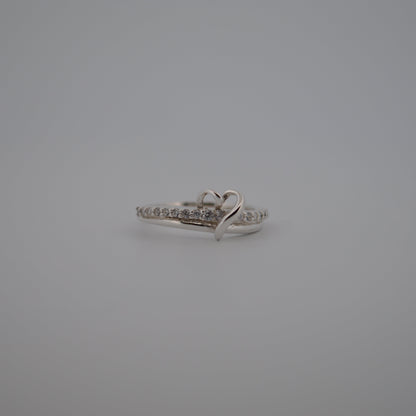 Silver ring with small diamonds on a gray background