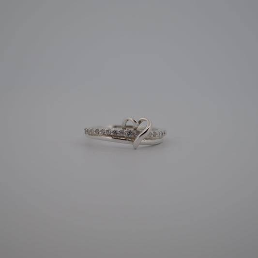 Silver ring with small diamonds on a gray background