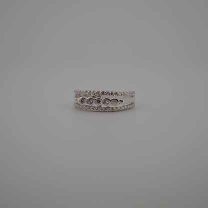 Silver ring with small stones on a gray background