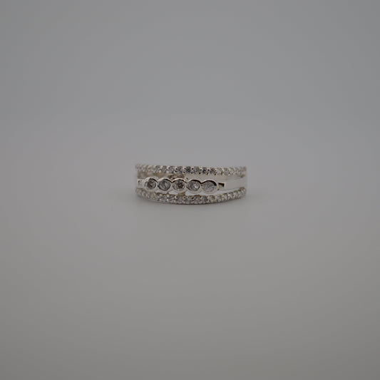 Silver ring with small stones on a gray background